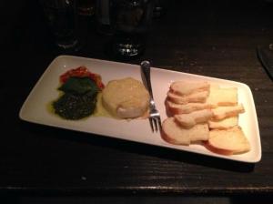 baked brie with basil pesto and red pepper jelly, served with crostini