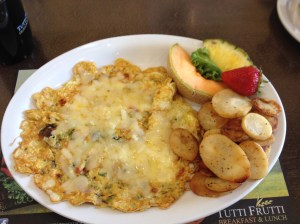 Veggie omelette with potatoes on the side.