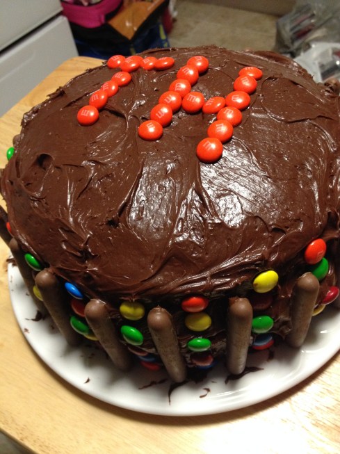 Three layer cake decorated with M&M's and Cadbury's Chocolate Fingers