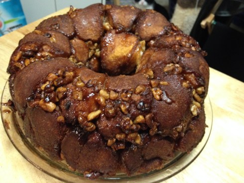 Pull Apart Cake - each dough ball is filled with cream cheese and chocolate chips then coated in sugar and cinnamon. Then the dough balls are topped with walnuts and a brown sugar glaze.