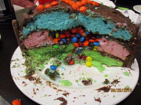 The inside of the three layer cake, it is filled with M&M's.